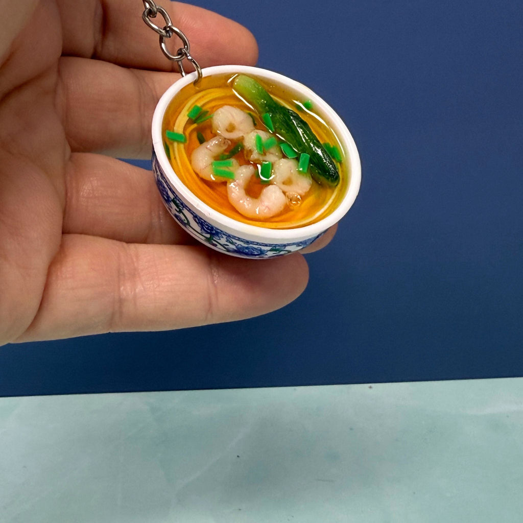 Mini bowl of shrimp ramen noodle keychain with realistic broth, noodles, shrimp, and veggies in a tiny ceramic-style bowl