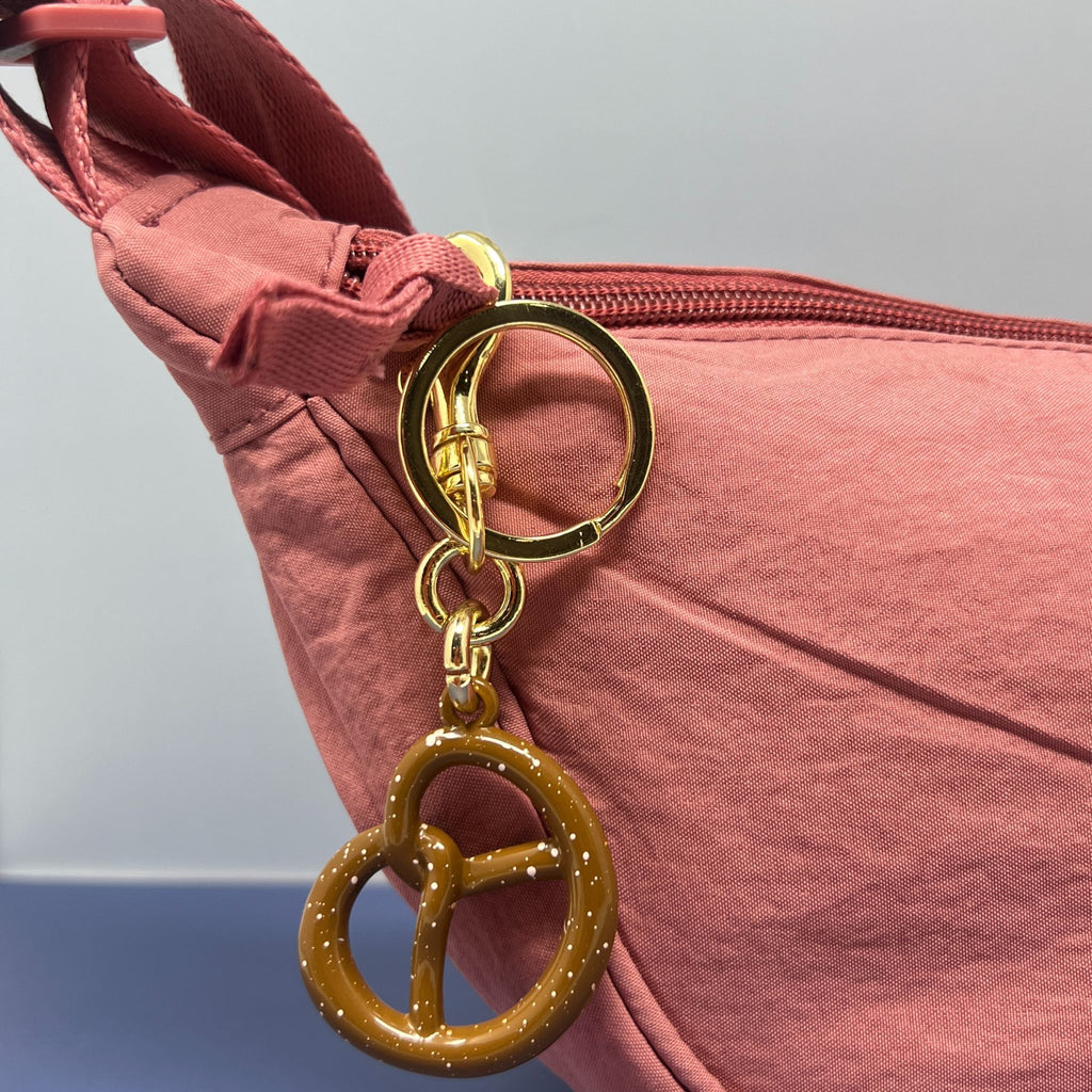 Pretzel-shaped keychain with glossy finish and gold keyring and lobster clasp