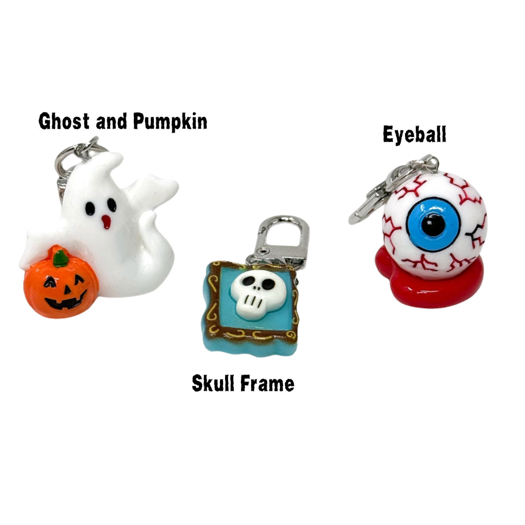 Halloween mini keychains including ghost, eyeball, pumpkin, mummy, and haunted house charms with silver clip rings