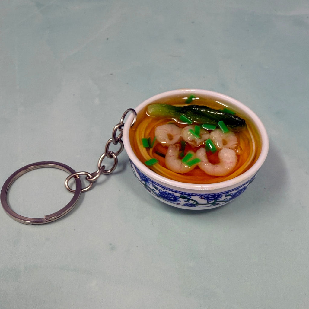 Mini bowl of shrimp ramen noodle keychain with realistic broth, noodles, shrimp, and veggies in a tiny ceramic-style bowl