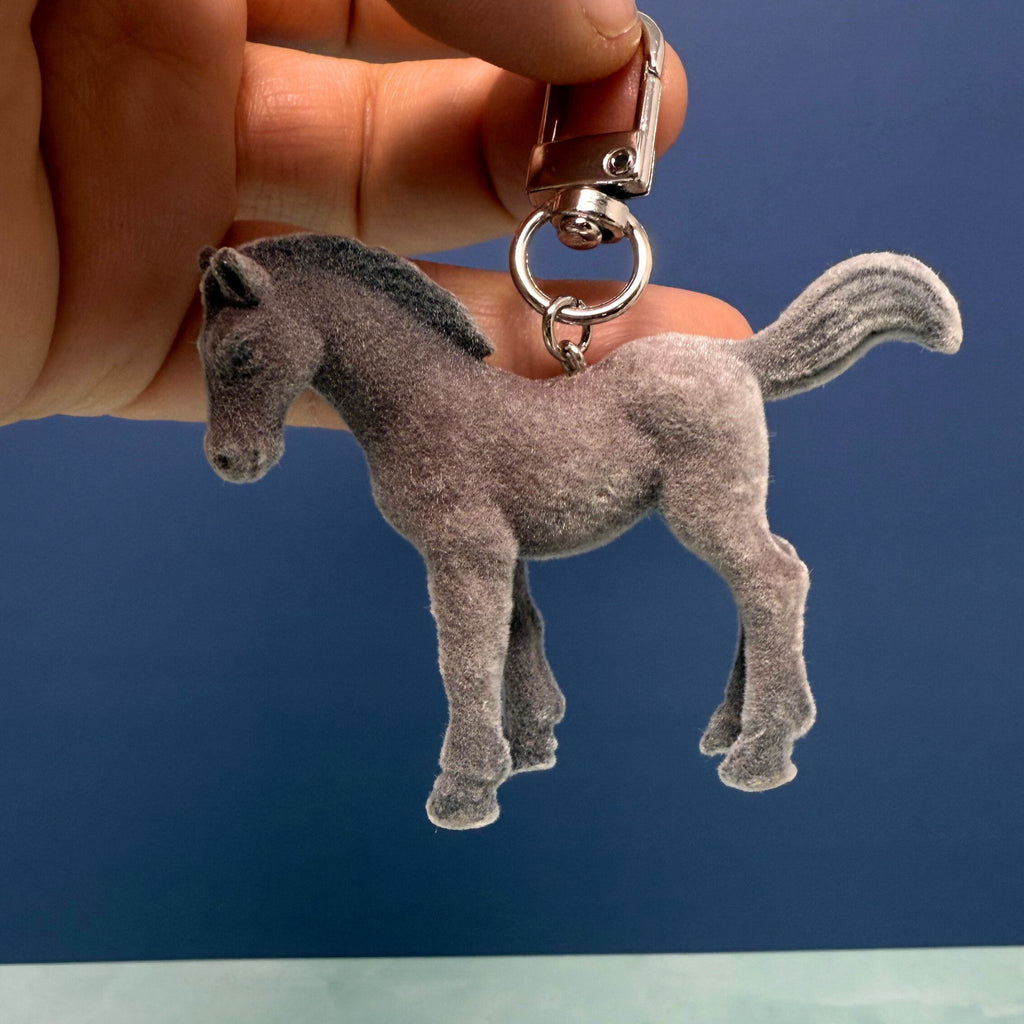 Soft flocked horse keychain with velvet texture and metal keyring, pony charm accessory for bags and keys