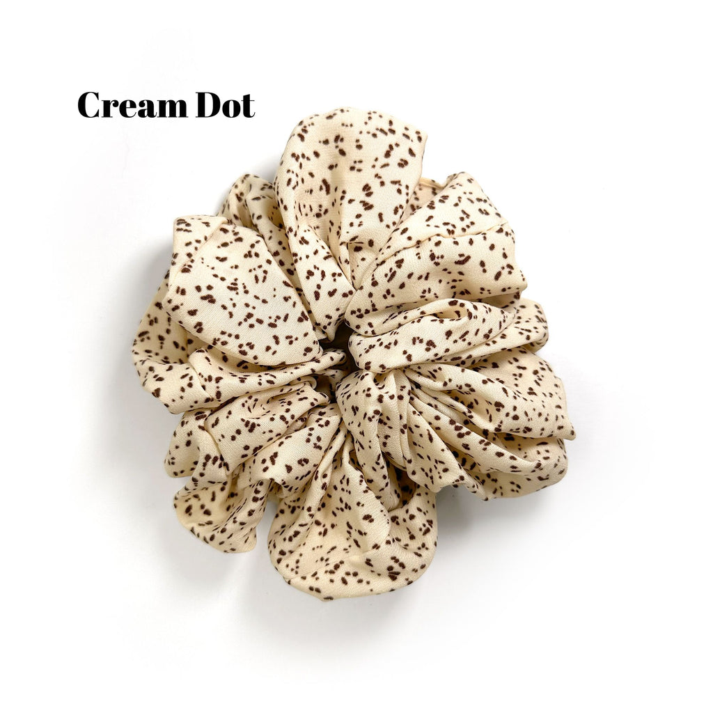 Soft oversized scrunchie in floral, leopard, and dotted patterns, perfect for stylish everyday hair looks.