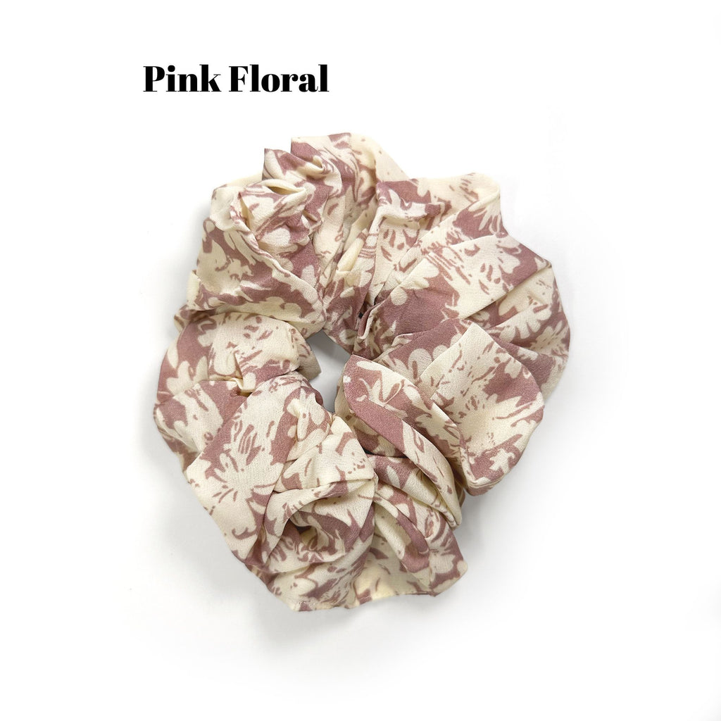 Soft oversized scrunchie in floral, leopard, and dotted patterns, perfect for stylish everyday hair looks.