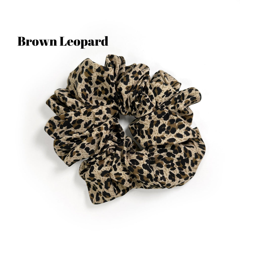 Soft oversized scrunchie in floral, leopard, and dotted patterns, perfect for stylish everyday hair looks.