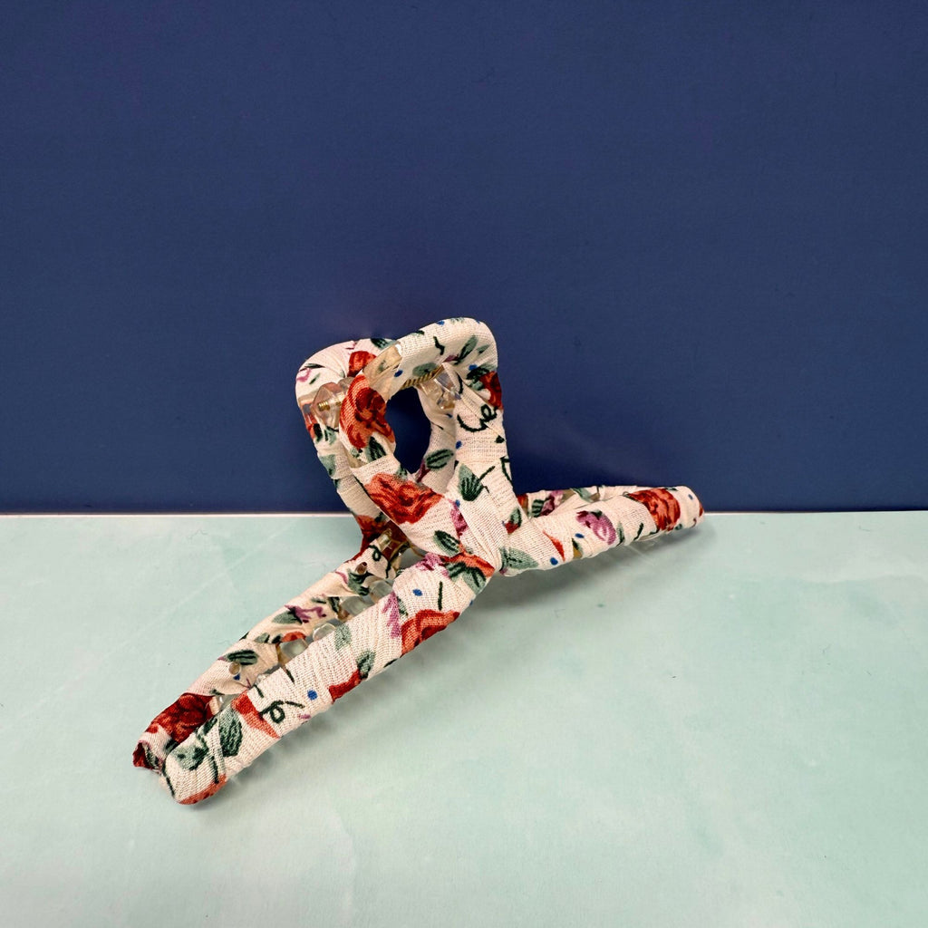 Floral-patterned dog toy on a light surface with a dark blue background