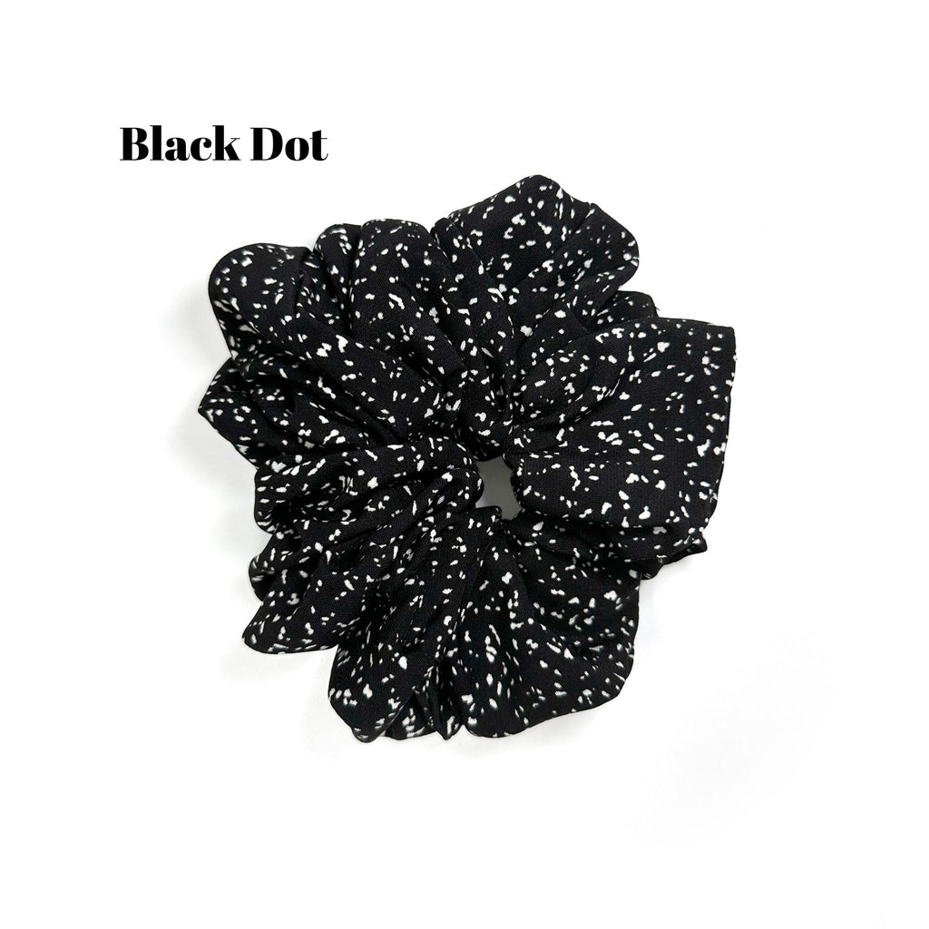Soft oversized scrunchie in floral, leopard, and dotted patterns, perfect for stylish everyday hair looks.