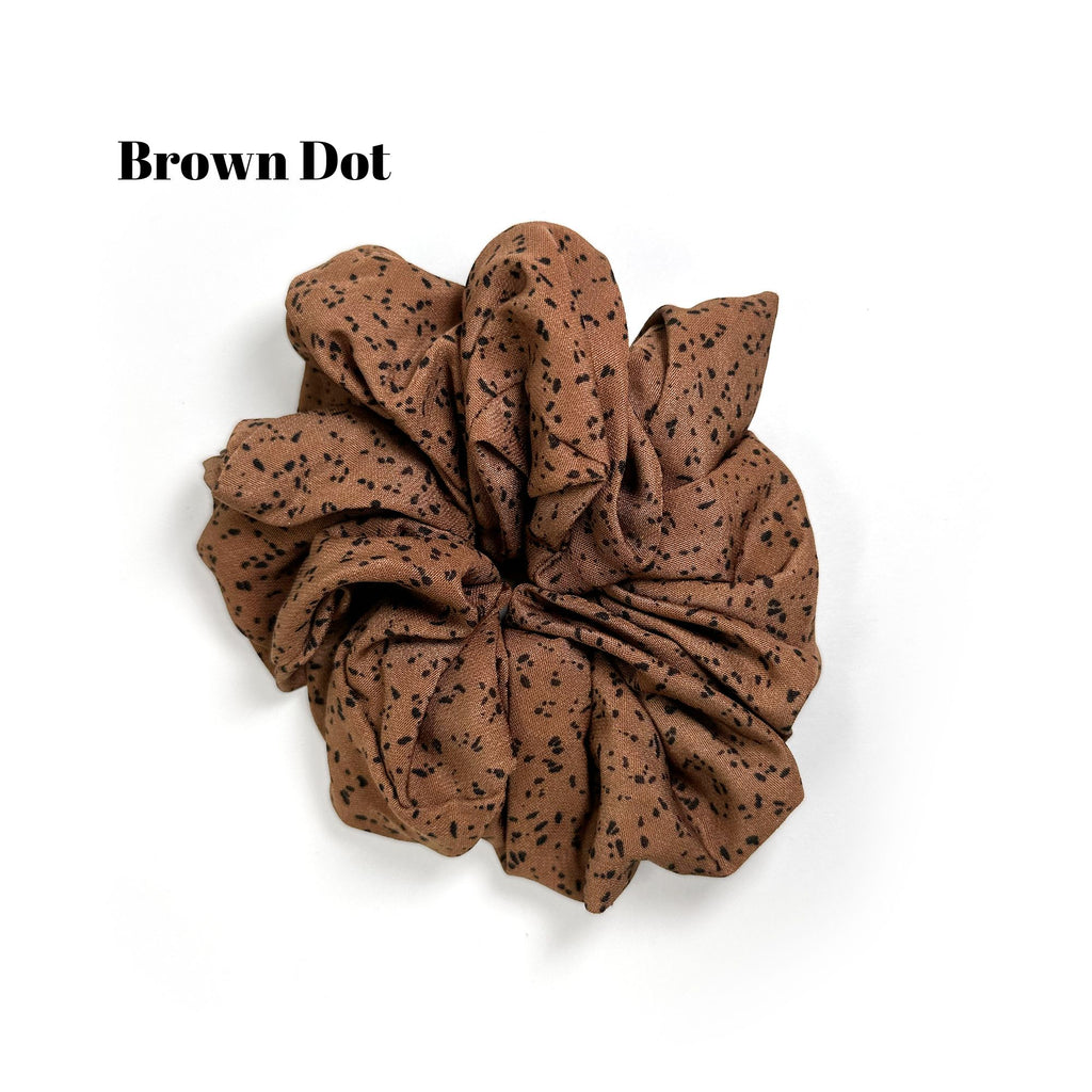 Soft oversized scrunchie in floral, leopard, and dotted patterns, perfect for stylish everyday hair looks.