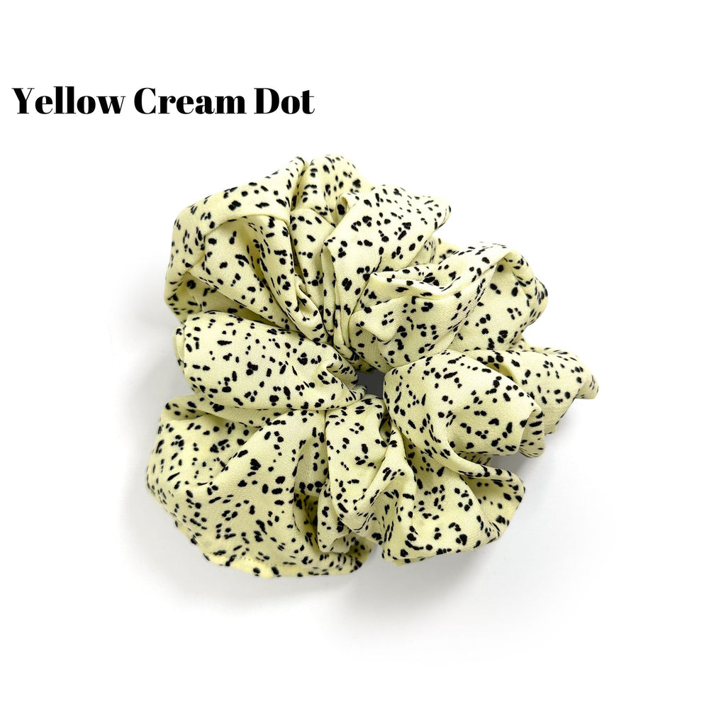 Soft oversized scrunchie in floral, leopard, and dotted patterns, perfect for stylish everyday hair looks.