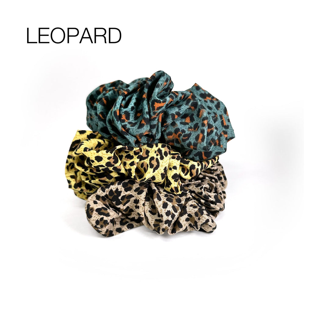 Soft oversized scrunchie in floral, leopard, and dotted patterns, perfect for stylish everyday hair looks.