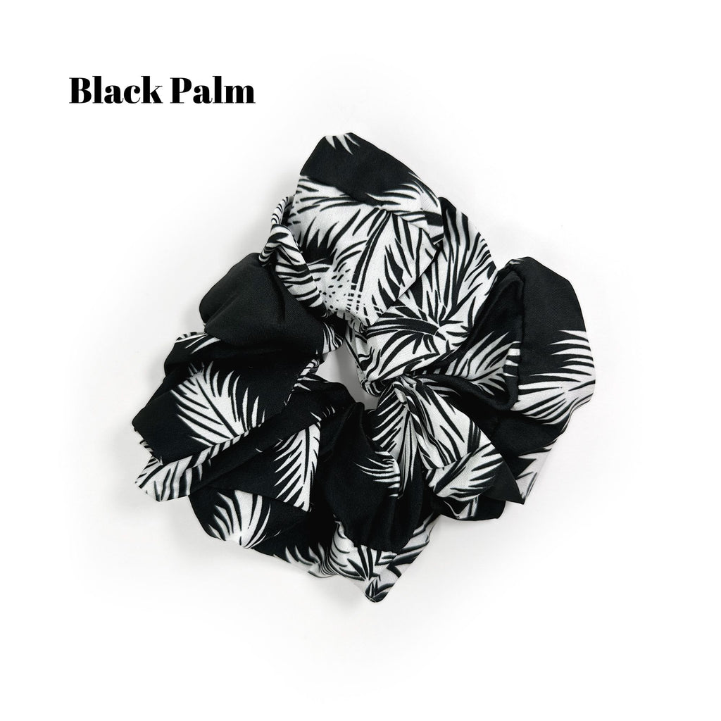 Soft oversized scrunchie in floral, leopard, and dotted patterns, perfect for stylish everyday hair looks.