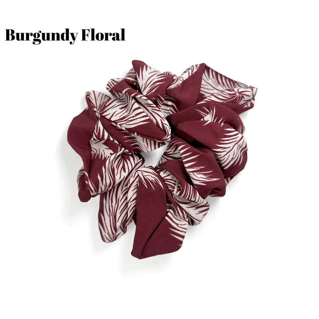 Soft oversized scrunchie in floral, leopard, and dotted patterns, perfect for stylish everyday hair looks.