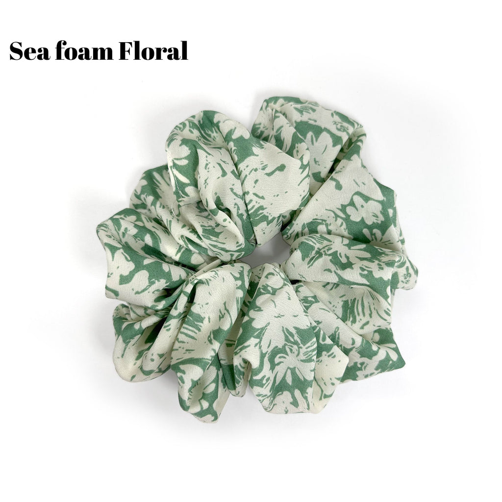 Soft oversized scrunchie in floral, leopard, and dotted patterns, perfect for stylish everyday hair looks.