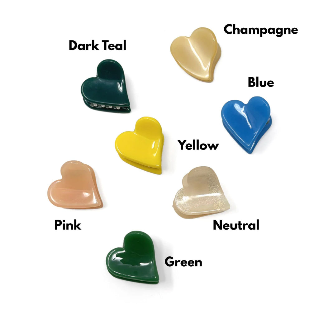 Set of two mini heart-shaped hair claws in shimmery beige and solid colors, made from durable acrylic with strong spring closure, each measuring approximately 1"H x 1"W.