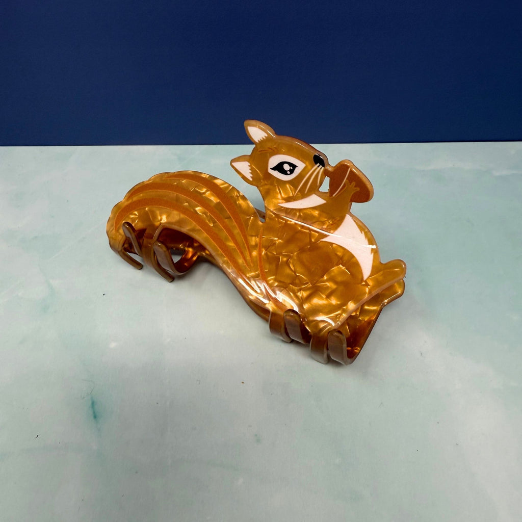 Squirrel hair claw clip with amber acetate finish, bushy tail design, and strong claw grip
