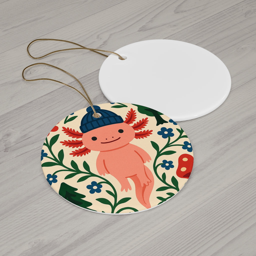 Round decorative tag with a cartoon axolotl wearing a blue hat on a wooden surface