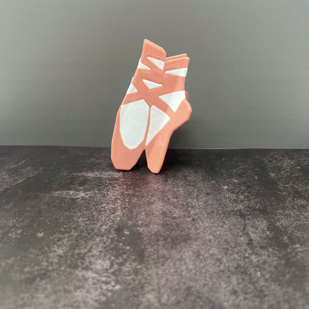 Pink ballet slipper-shaped hair claw clip with ribbon ties for balletcore or coquette hairstyles