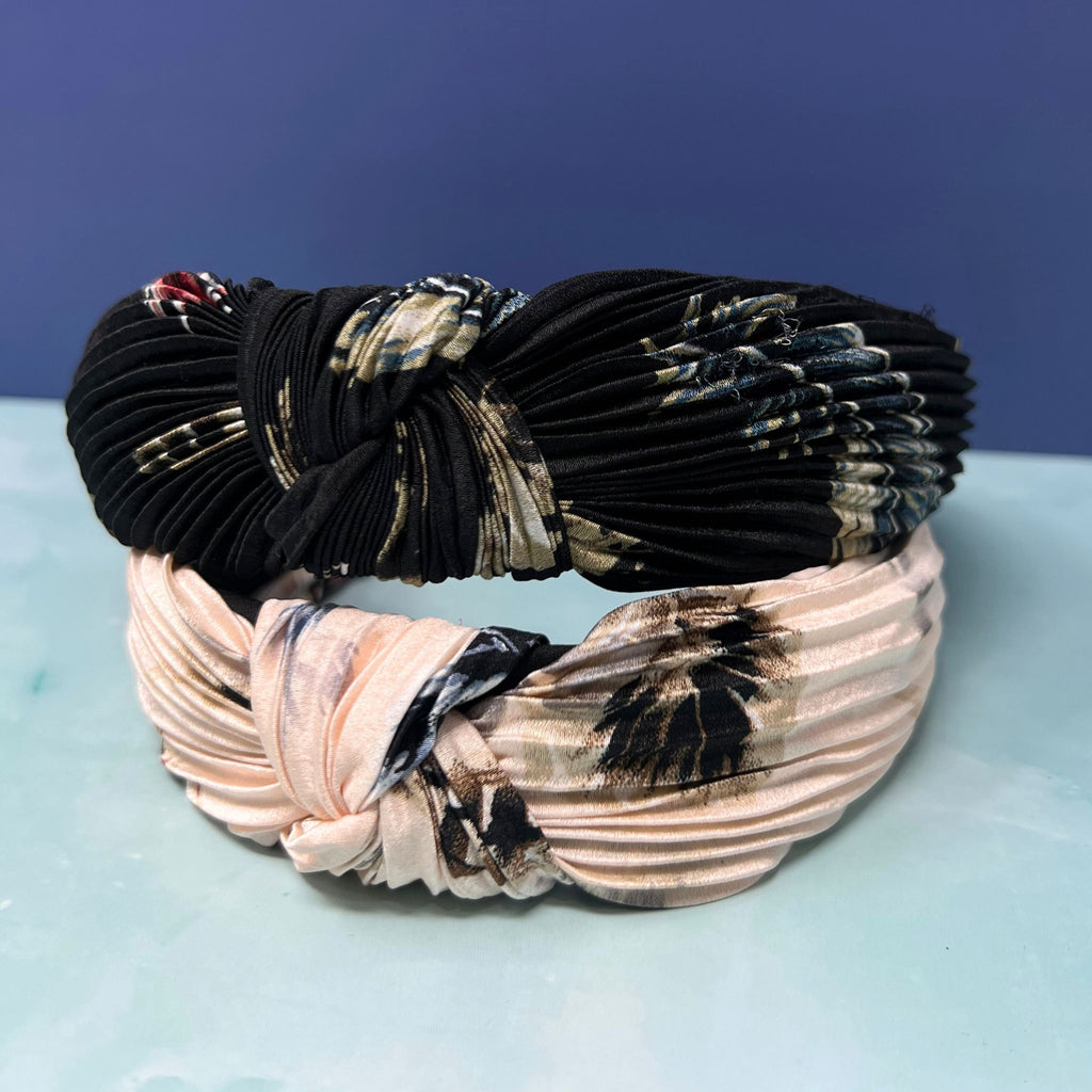 Pleated knot headbands in abstract black and blush prints stacked together with textured crinkle fabric.